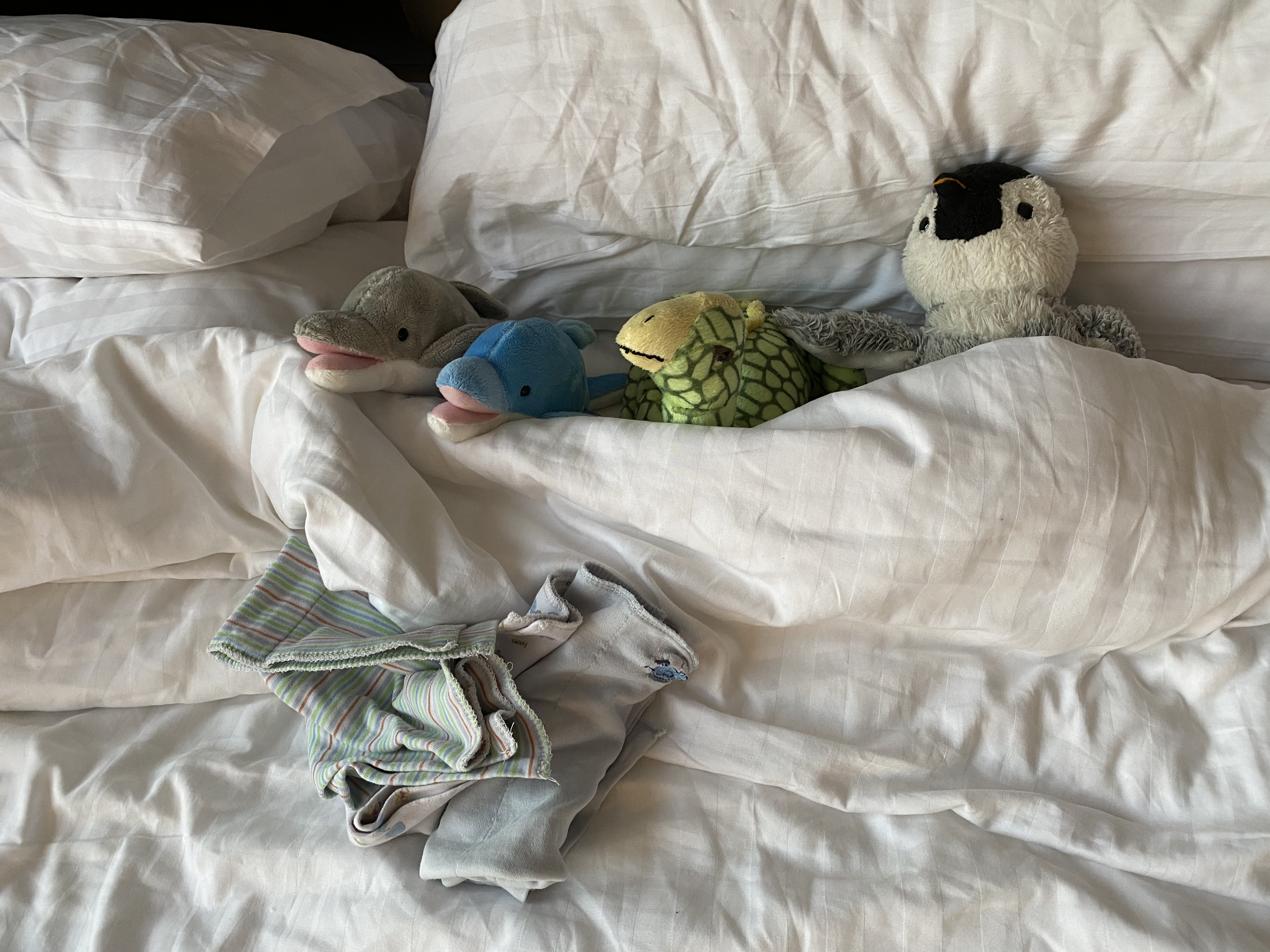 Stuffed animals in bed